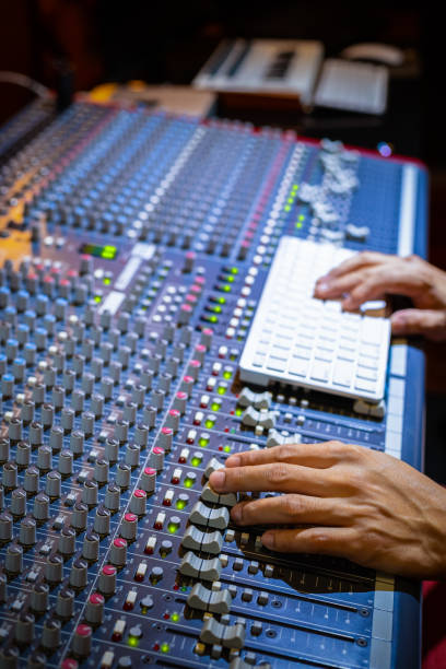 istock male producer, sound engineer hands working on audio mixing console in broadcasting, recording studio 1188329511