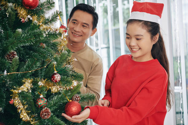 istock Teen girl decorating tree 1188329758