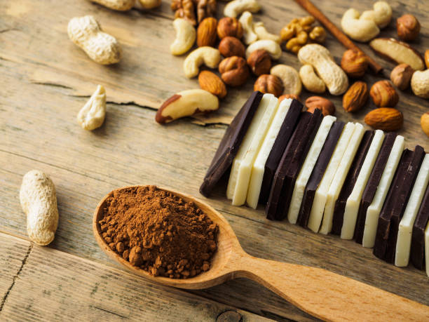 istock Chocolate, nuts, raisins and cocoa spoon on wooden surface 1188329765