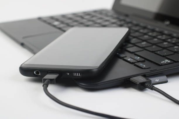 istock Touchscreen phone connected to a laptop 1188332815