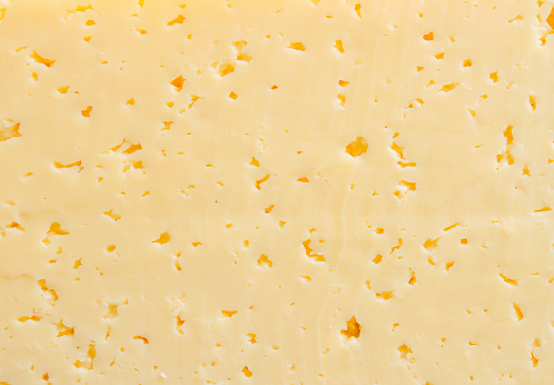 Yellow cheese texture for food background.