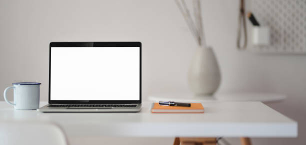 istock Close-up view of modern workplace with open laptop computer with office supplies 1188340499