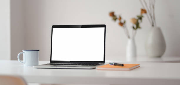 istock Cropped shot of modern workplace with open laptop computer with office supplies 1188340525