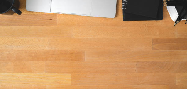 istock Top view of comfortable workspace with laptop computer, office supplies and copy space on wooden table 1188340536