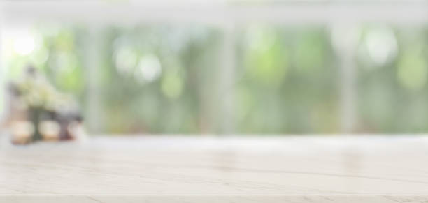 istock Close-up view of empty marble table and copy space with blurred windows background 1188340606