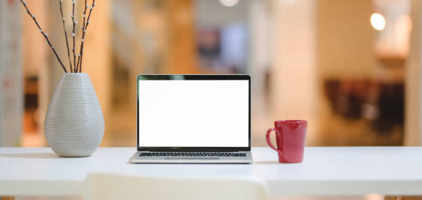 istock Close-up view of comfortable workplace with mock up laptop computer, red coffee cup and decorations 1188340609