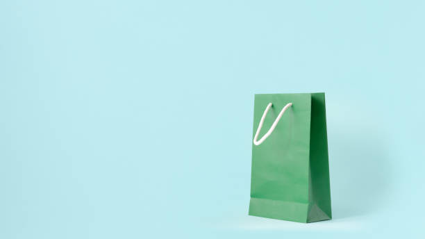 istock Green shopping bag on mint pastel color background. 1188341518