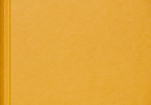 Close up of a yellow book cover background.