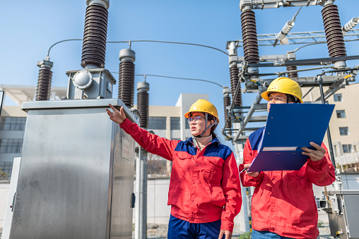 Power engineer checking electrical equipment at substation