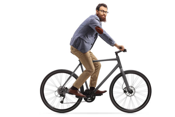 istock Bearded guy riding a bicycle and looking at the camera 1188342672