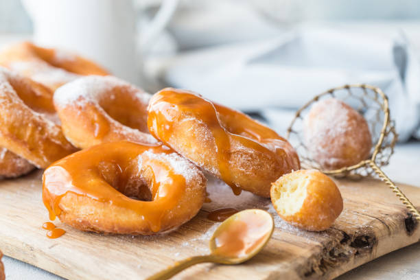 istock Glazed caramel doughnuts. A close up of fresh glazed doughnuts in a studio setting. donut 1188342986
