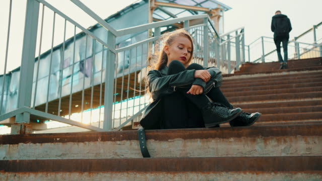 Teenage Girl in Leather Jacket Sitting on Stairs