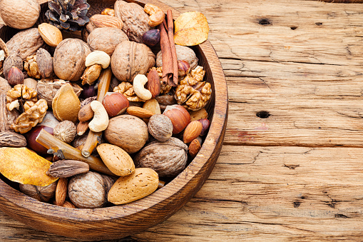 Nuts mix in wooden plate.Organic food.Different types of nuts.