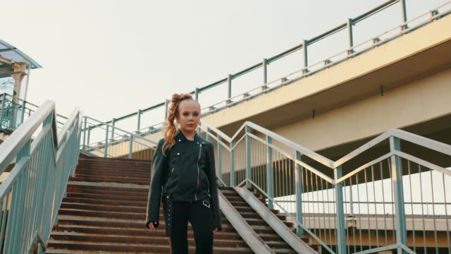 Teenage Girl in Leather Jacket Walking Downstairs