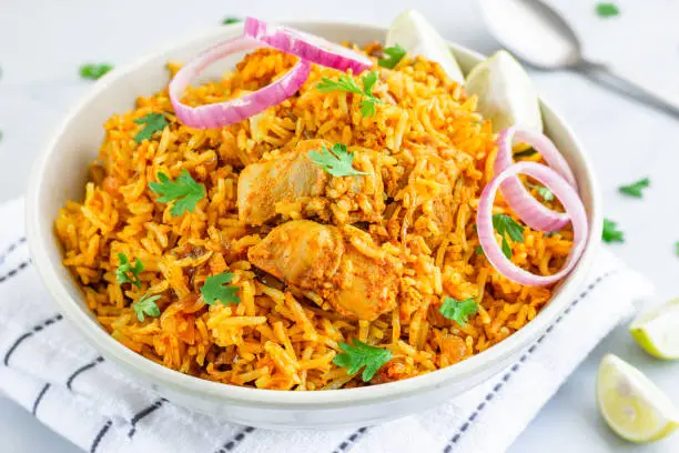Indian Chicken Pulao, Chicken Fried Rice with Lemon and Onion, Close-Up Photography.