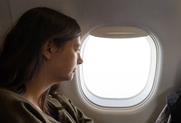 istock Young caucasian woman flying by plane 1188348978