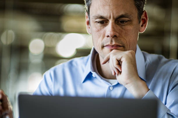 istock Pensive male entrepreneur reading an e-mail on laptop in the office. 1188354052