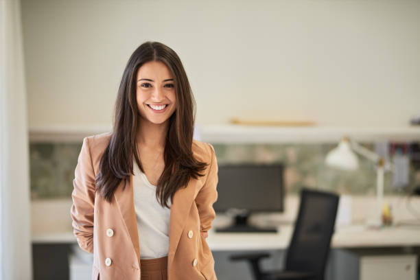 istock Smiling businesswoman standing in an empty office. 1188357859