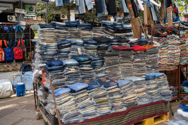 Piles and stacks of denim jeans for sale at Nehru Place market in South Delhi India, which is better known for its electronic items for sale stock photo