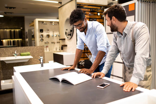 istock Shopkeeper helping a shopper in planning for a bathroom renovation in a specialized bathroom equipment store 1188363414