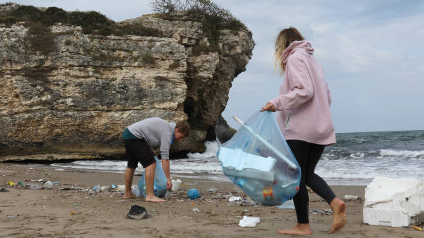 istock Friends pick up garbage on beach 1188364455