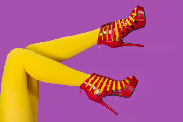 istock Beautiful legs in shiny red patent high heels 1188364862