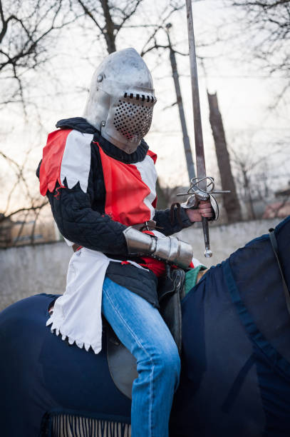 chevalier médiéval avec une épée conduisant un cheval - bride bouquet photos et images de collection