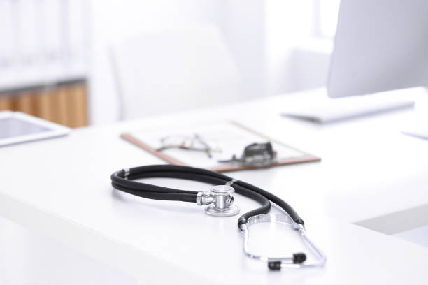 istock Stethoscope, prescription medical form lying on a table with pc computer. Medicine or pharmacy concept. Medical tools at doctor working table 1188366681