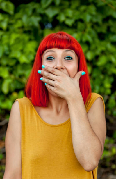 istock Surprised red haired woman in a park 1188367984
