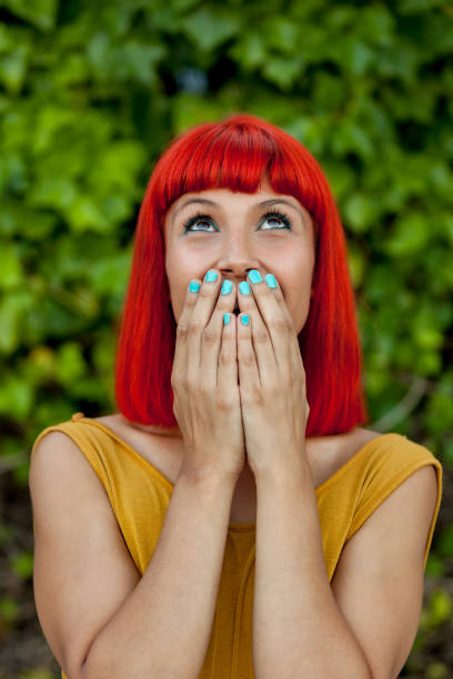 istock Surprised red haired woman in a park 1188368033