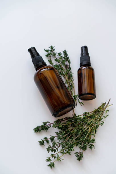 istock Organic products in bottles and fresh thyme herb flat lay composition on white, vertitcal orientation. 1188369143