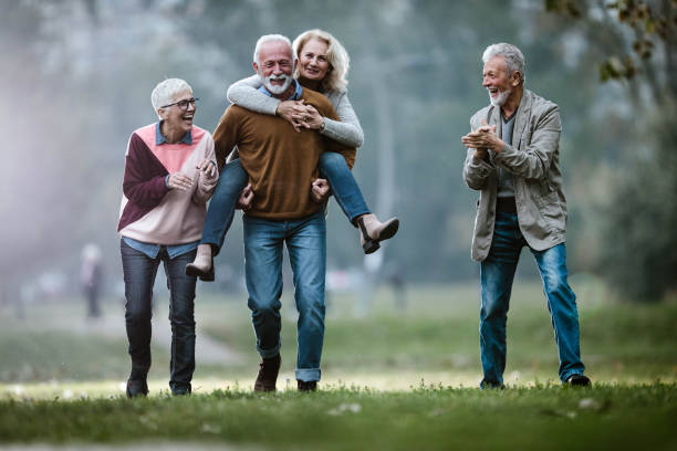 istock Playful mature couples having fun during autumn day in nature. 1188369772