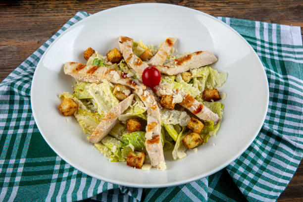 istock Gourmet caesar salad with grilled chicken croutons. Caesar salad with chicken, cherry tomatoes, lettuce. 1188371359