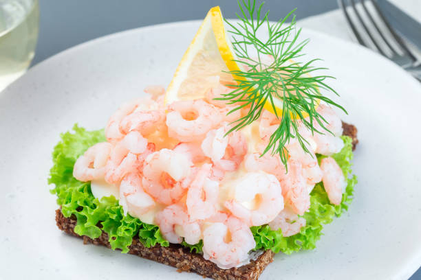 istock Traditional savory swedish sandwich with a dark bread, lettuce, eggs, mayonnaise, shrimps, dill and lemon, horizontal 1188373349