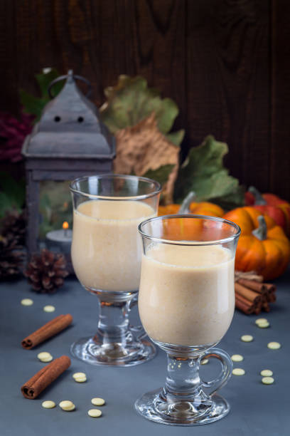 istock Hot white chocolate with pumpkin and spices, autumn decorations on background, vertical 1188374036