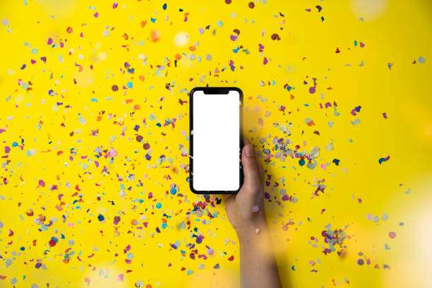 istock Hands holding smart phone on yellow background 1188374556
