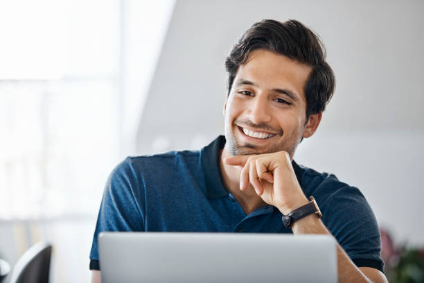 istock Smiling male professional using laptop at office 1188375462
