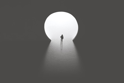 man walking toward keyhole light door, photography key concept