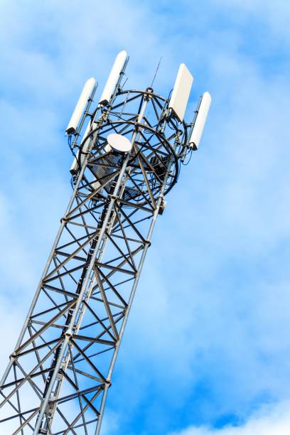 istock Telecommunication mast against blue sky. Autumn landscape with flagpole. Modern broadcast technology. 1188376786