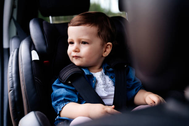 istock Cute little baby into a car having fun 1188376905