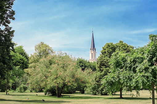 Summer landscape and old church Maria Hietzing by blue sky in Vienna, Austria