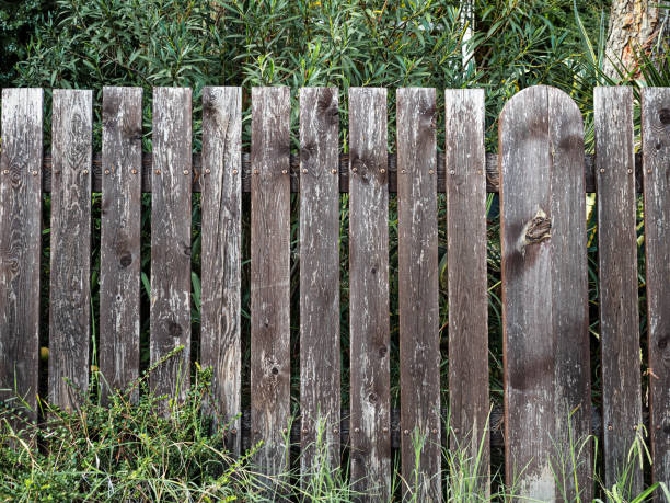 istock Old low and painted fence on a cloudy day front view 1188379897