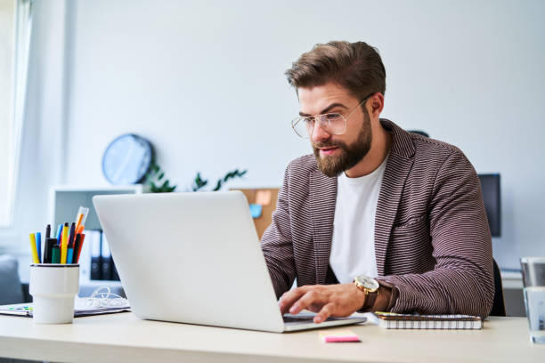 istock Busy freelancer working on laptop at home office 1188380342