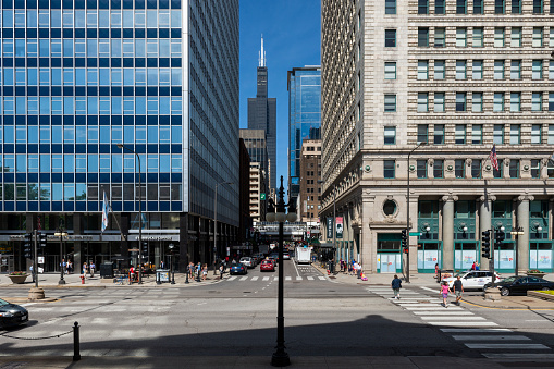 Chicago, Illinois, USA - July 1, 2014: Street scene in the downtown of the city of Chicago, with people crossing a street.