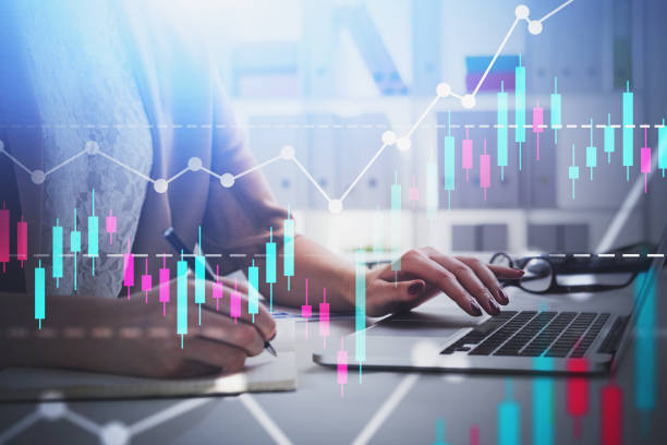 istock Woman typing on laptop in office, graphs 1188381306