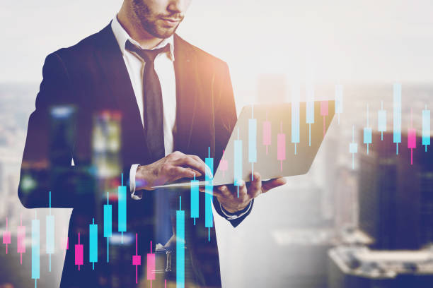 istock Man with laptop in city, financial graph 1188381521