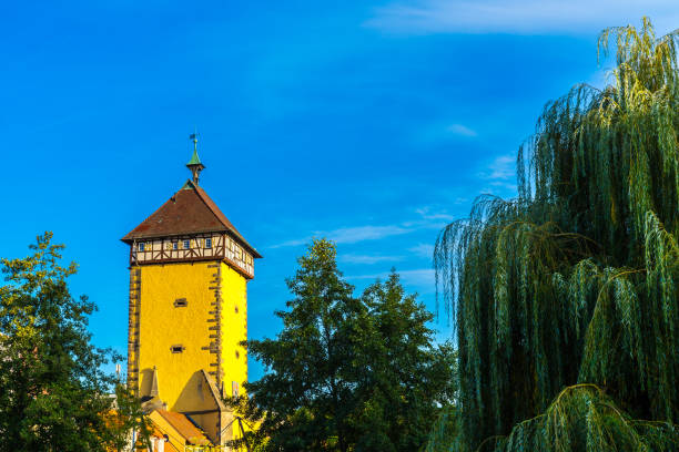 Germany, Famous city gate of old town in reutlingen next to a willow tree, it is called mettmannstor or tuebinger tor in warm sunset light with blue sky Germany, Famous city gate of old town in reutlingen next to a willow tree, it is called mettmannstor or tuebinger tor in warm sunset light with blue sky reutlingen stock pictures, royalty-free photos & images
