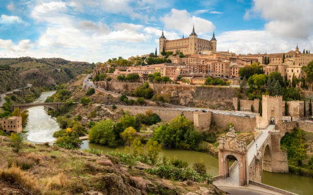 Toledo view from alcantara bridge, Spain Toledo cityscape with Alcantara bridge (Puente de Alcantara) over Targus river. Spain madrid city view stock pictures, royalty-free photos & images
