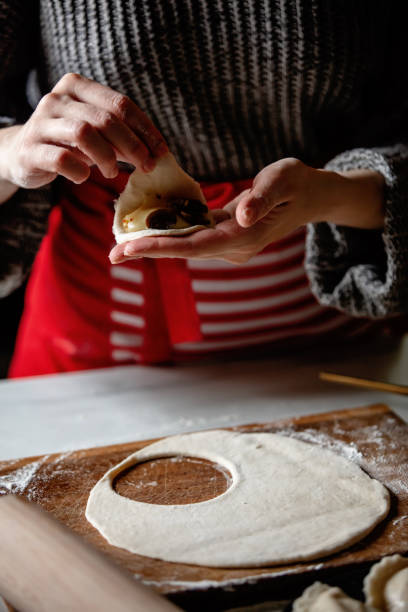 istock woman cooking  polish dumplings at kitchen 1188382669