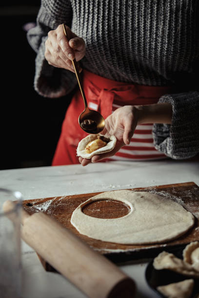 woman cooking  polish dumplings at kitchen